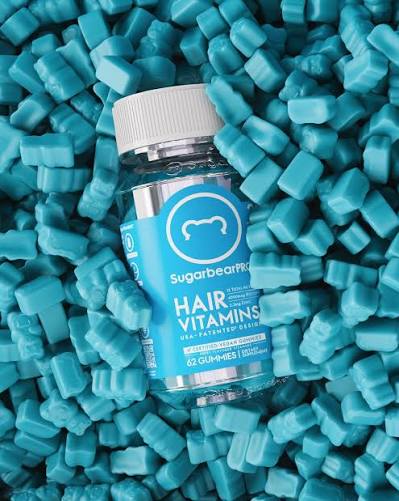 SugarBearPRO hair vitamins bottle surrounded by blue gummy bears